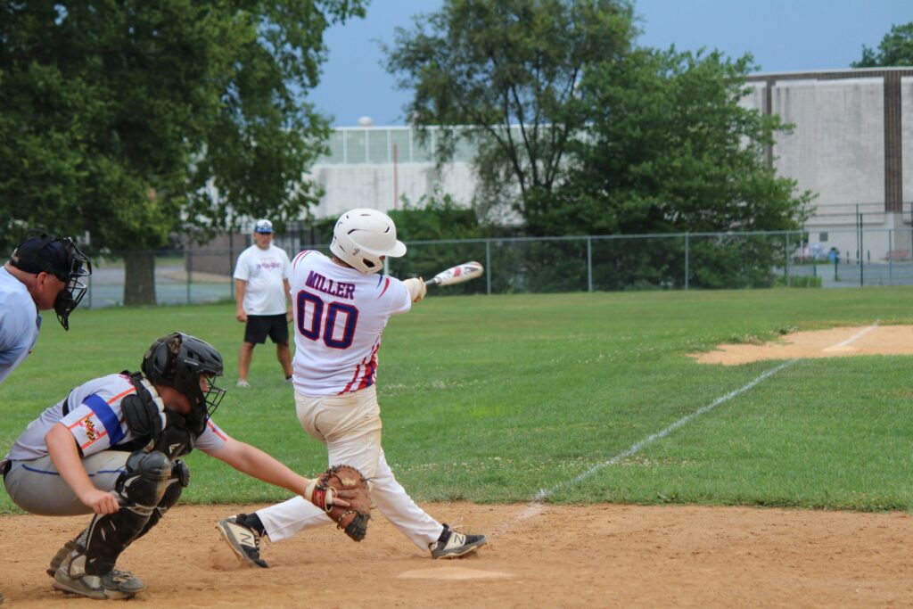 in the dirt member in white jersey batting