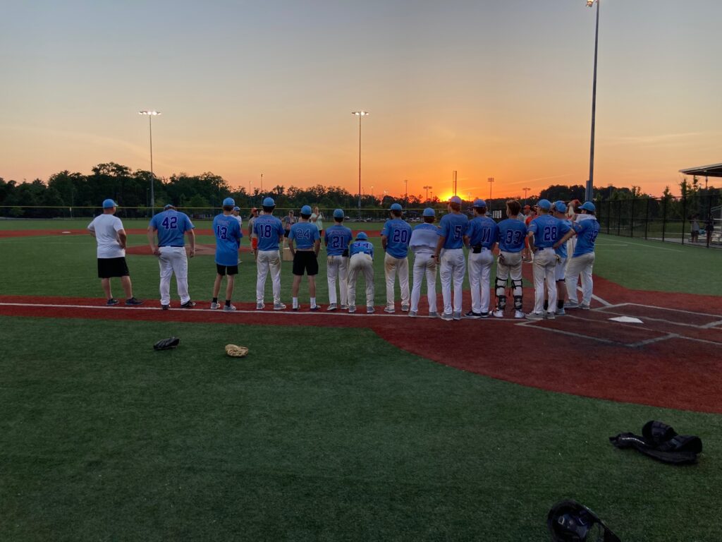 in the dirt team standing on diamond during a sunset